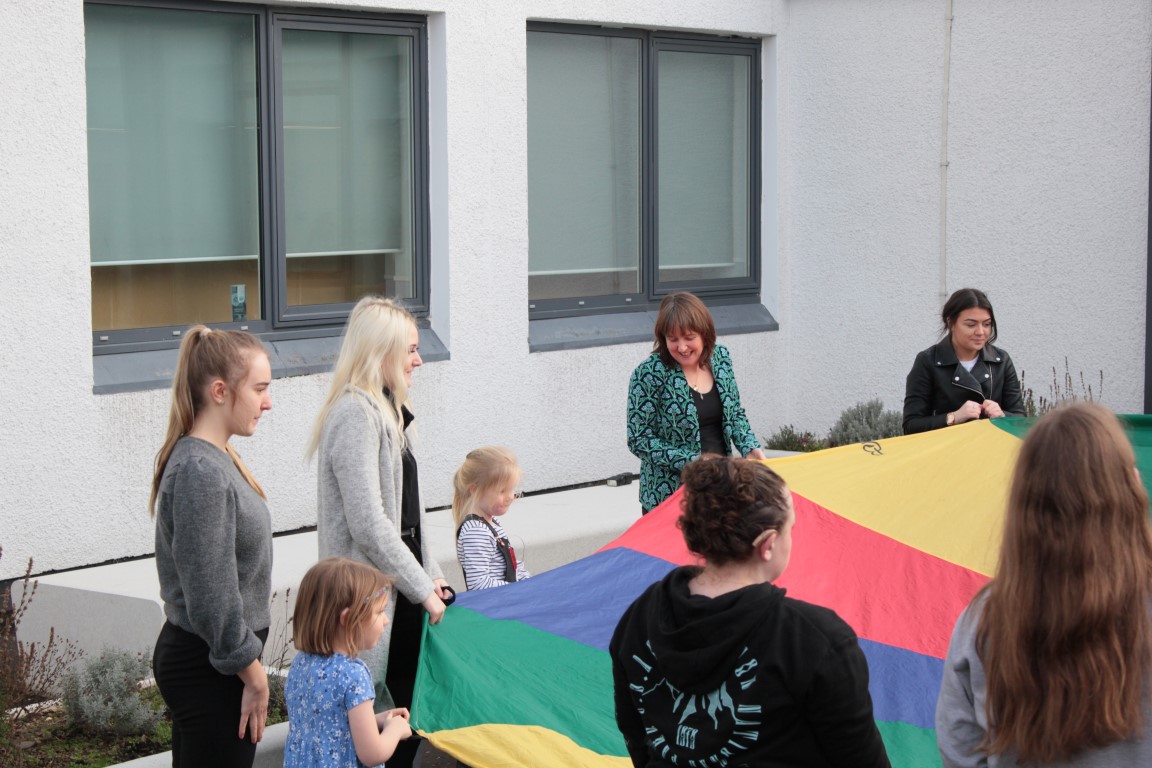 Maree Todd with students and children, outdoors