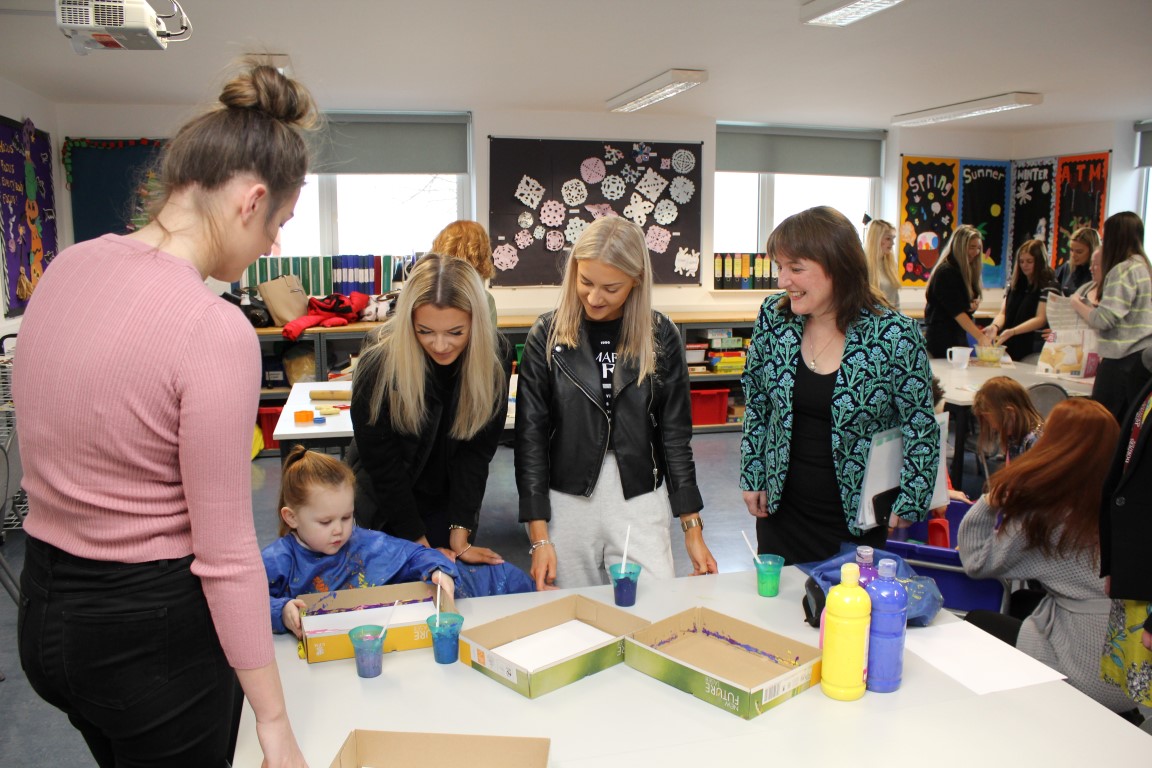 Maree Todd with students and children, in a classroom