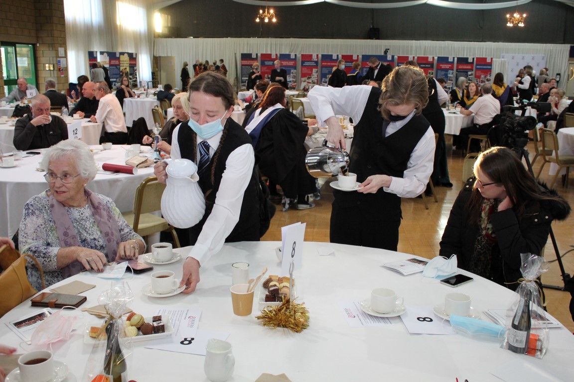 Students serving tea and coffee