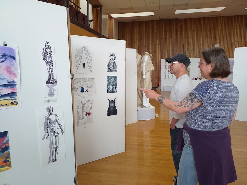 People looking at art exhibition work