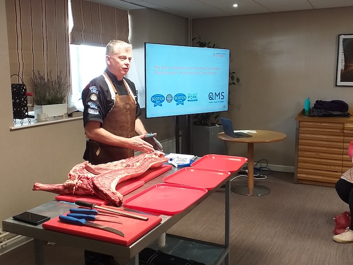 Man butchering a lamb carcas