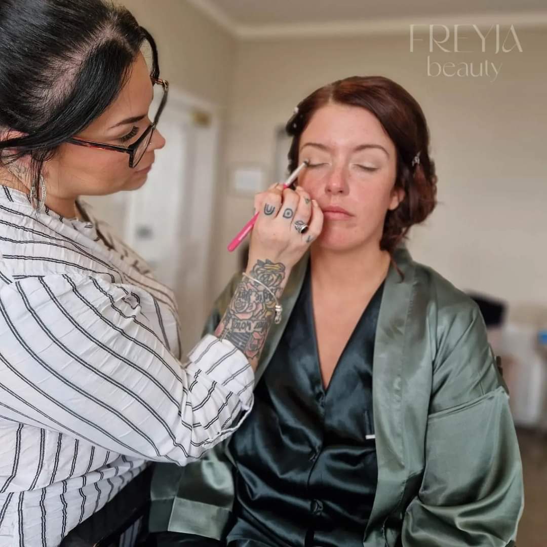 Photo of someone having make up applied
