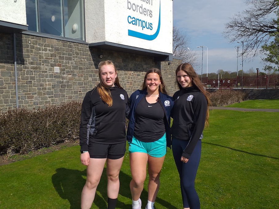 Group of female rugby players outside building
