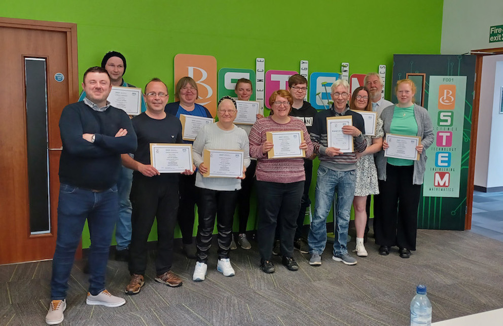 Group of people standing with certificates