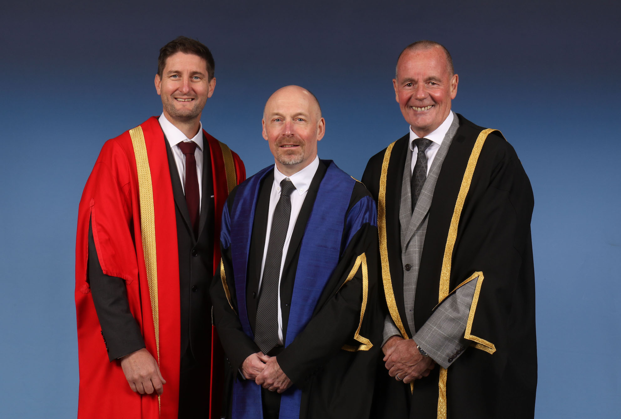 Photo of 3 official party guests at graduation