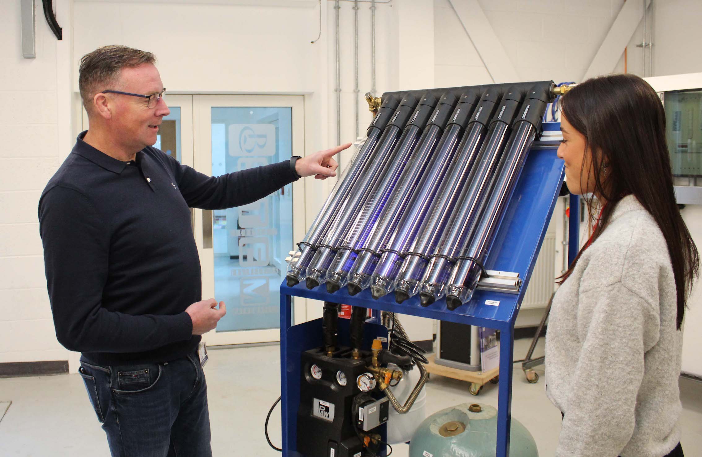 Two people looking at renewables technology kit