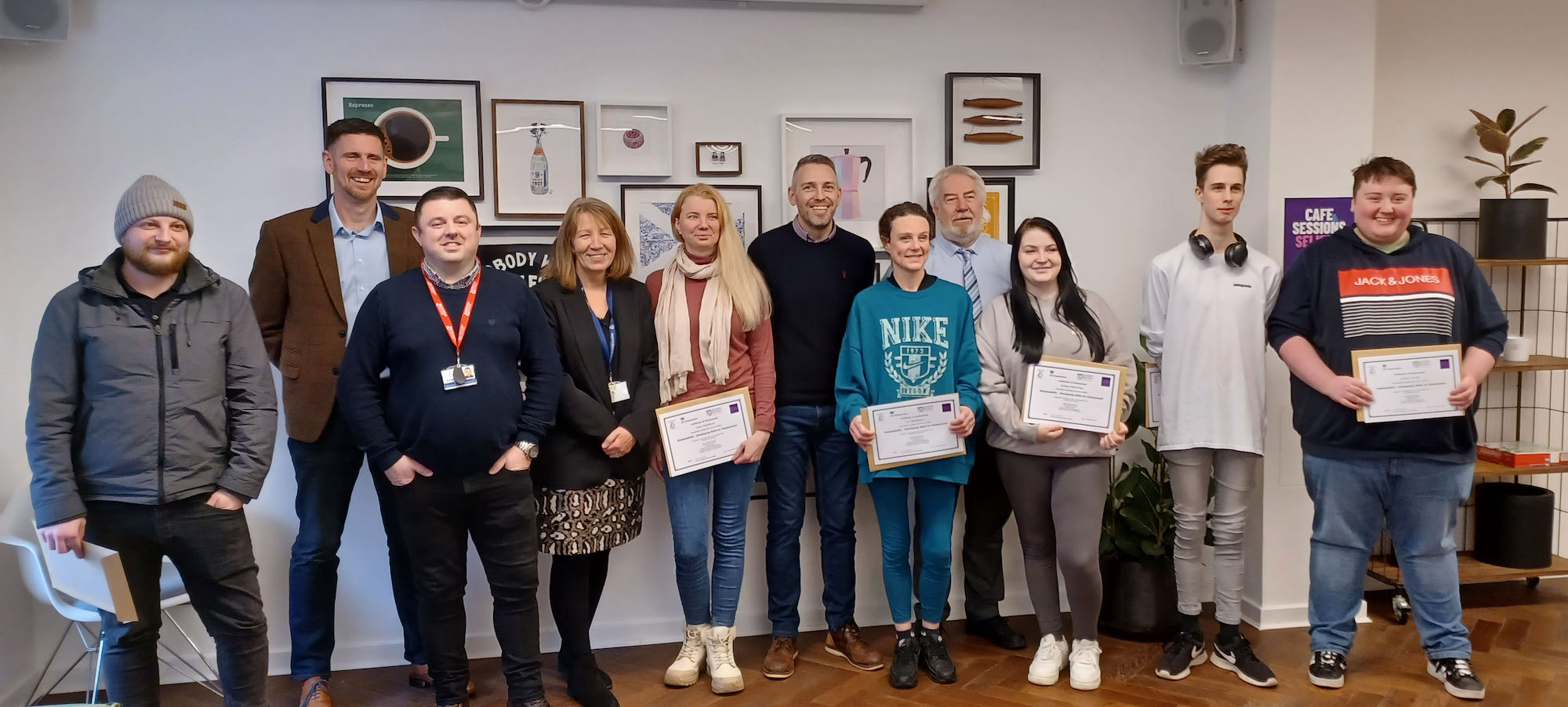 Group of people standing with certificates