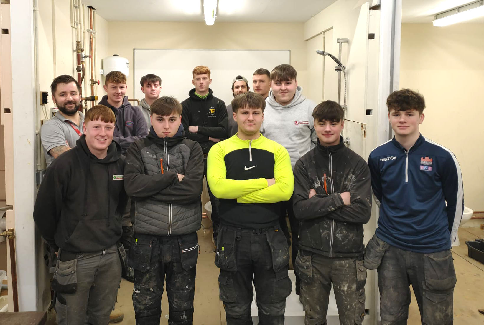 Group of plumbing students inside the plumbing workshop