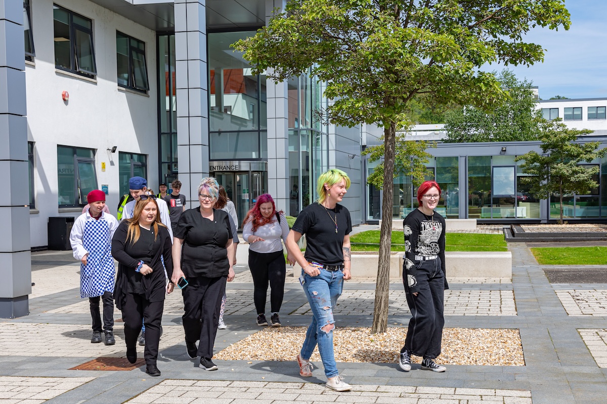 Group of students walking outside a college building