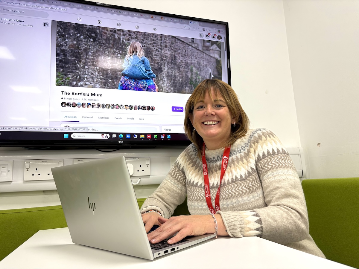 Photo of Susan Cooper using a laptop in a classroom setting