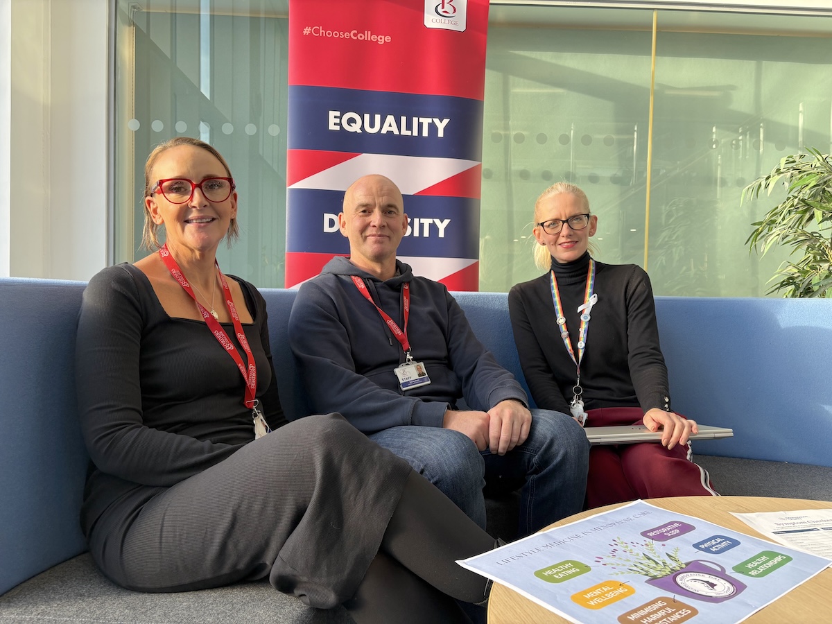 Group of three Borders College Staff members sitting in a library setting 