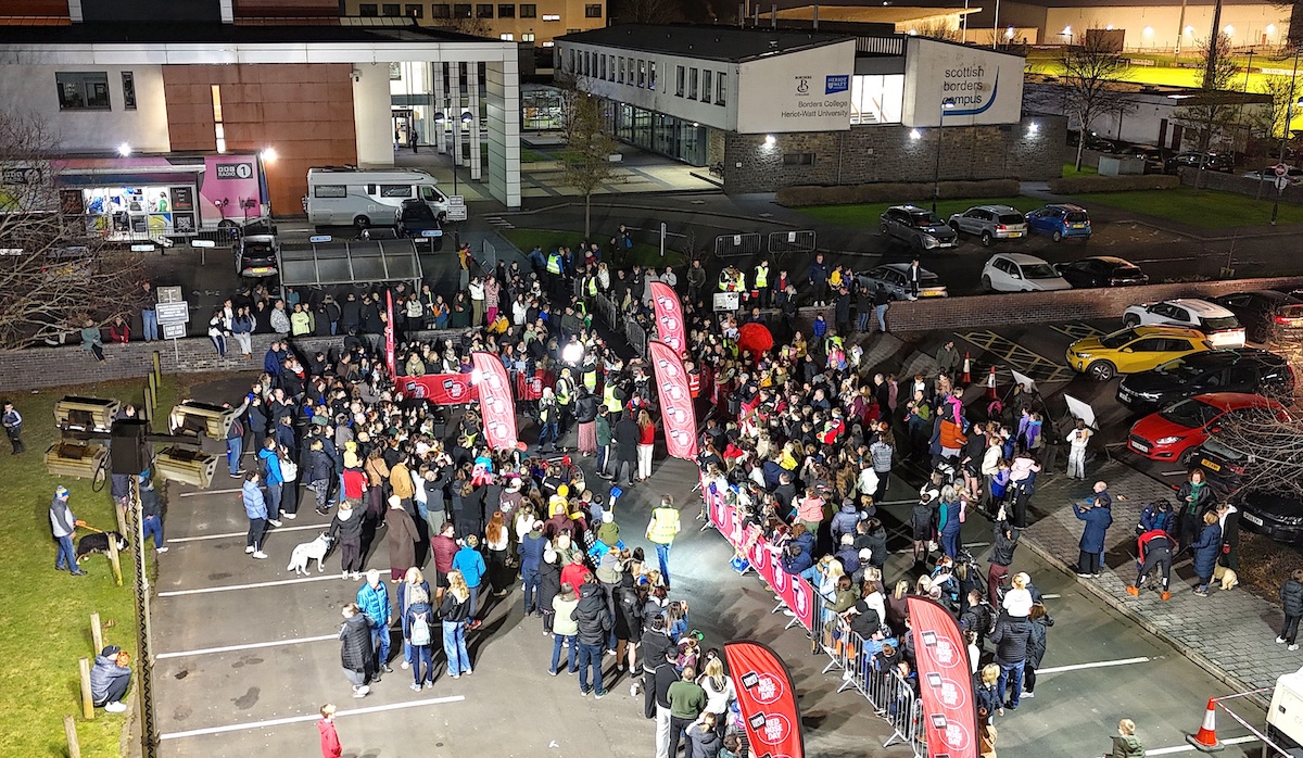 Drone photo of a crow of people standing outside the scottish borders campus