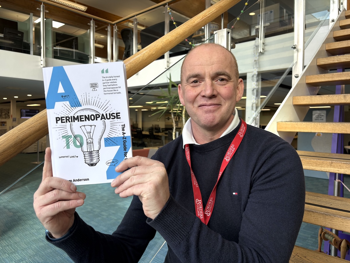 Photo of Sam Anderson holding his book