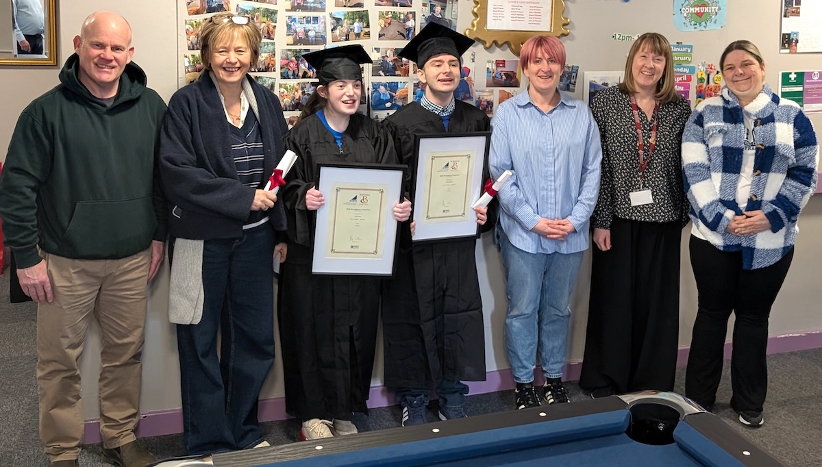 Group of staff and students. Students are being presented with completion certificates
