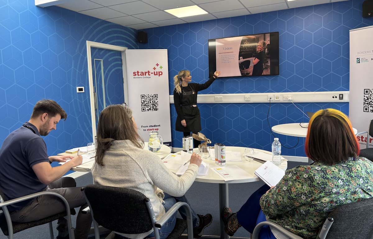 Photo showing a student presenting to a judging panel