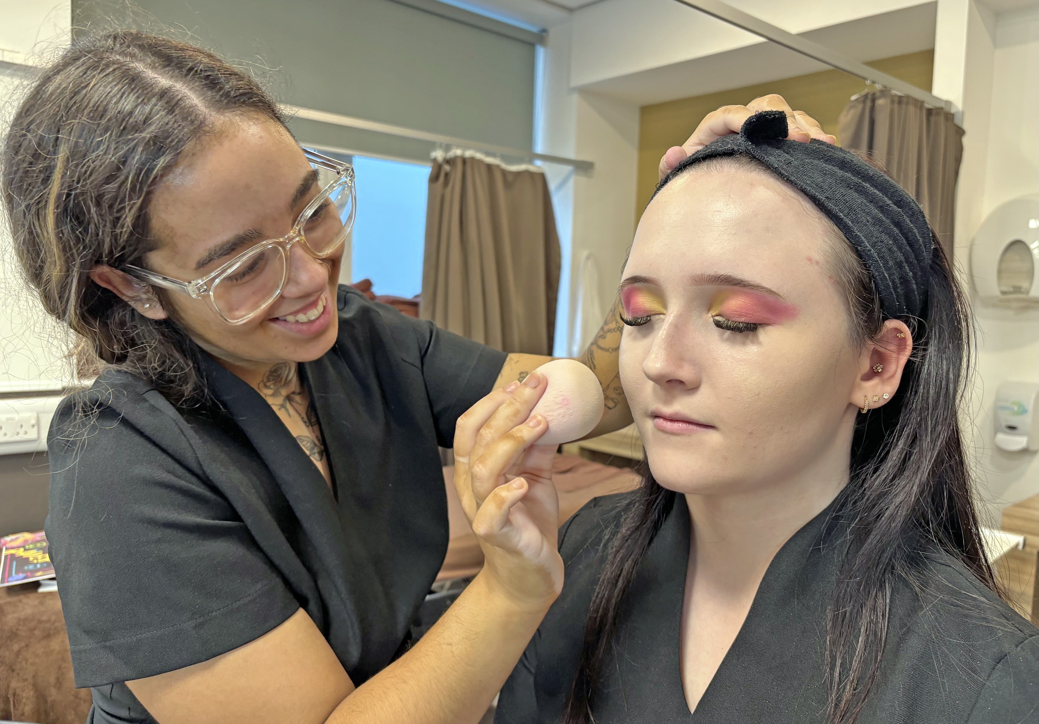 Make-up being applied by female student
