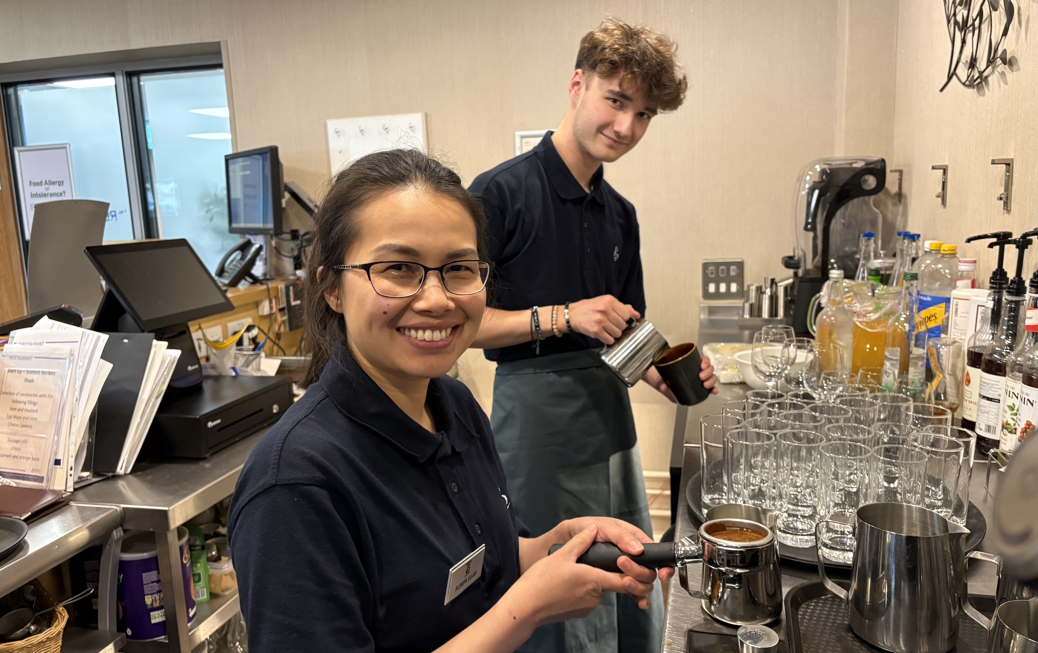 Female and male students preparing coffees