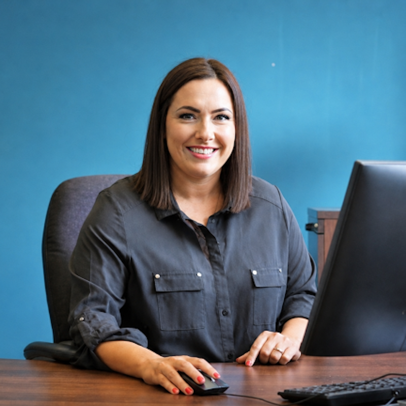 Photo of Gillian McMillan sitting at a desk