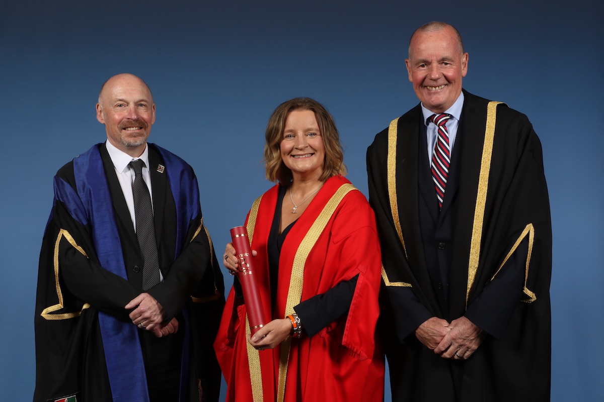Two Borders College staff members standing alongside Honorary Fellow Suzanne Mulholland