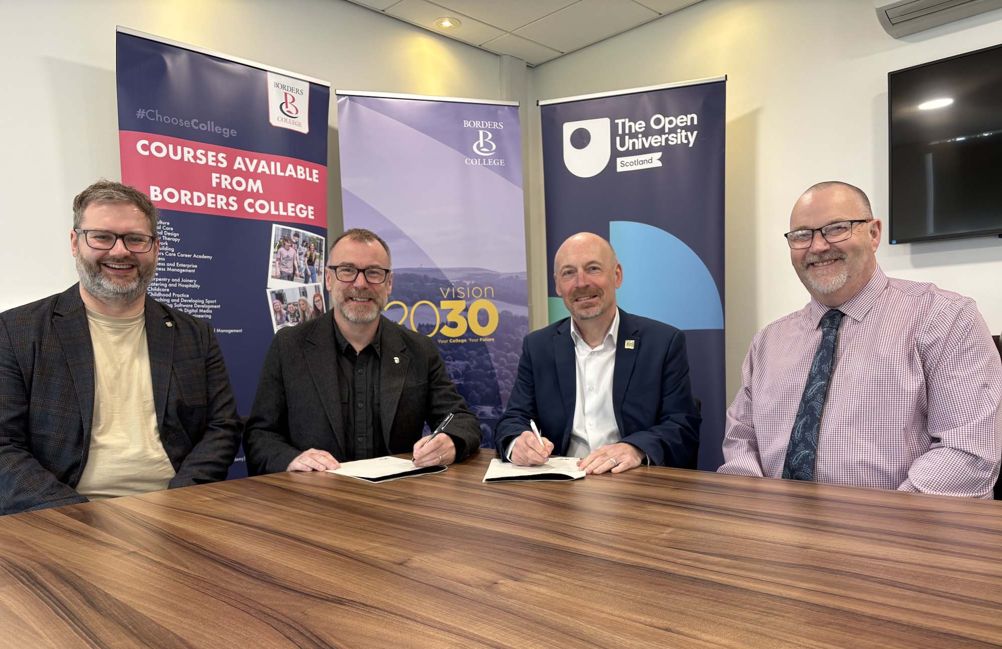 Photo of Borders College and Open University staff members signing an agreement